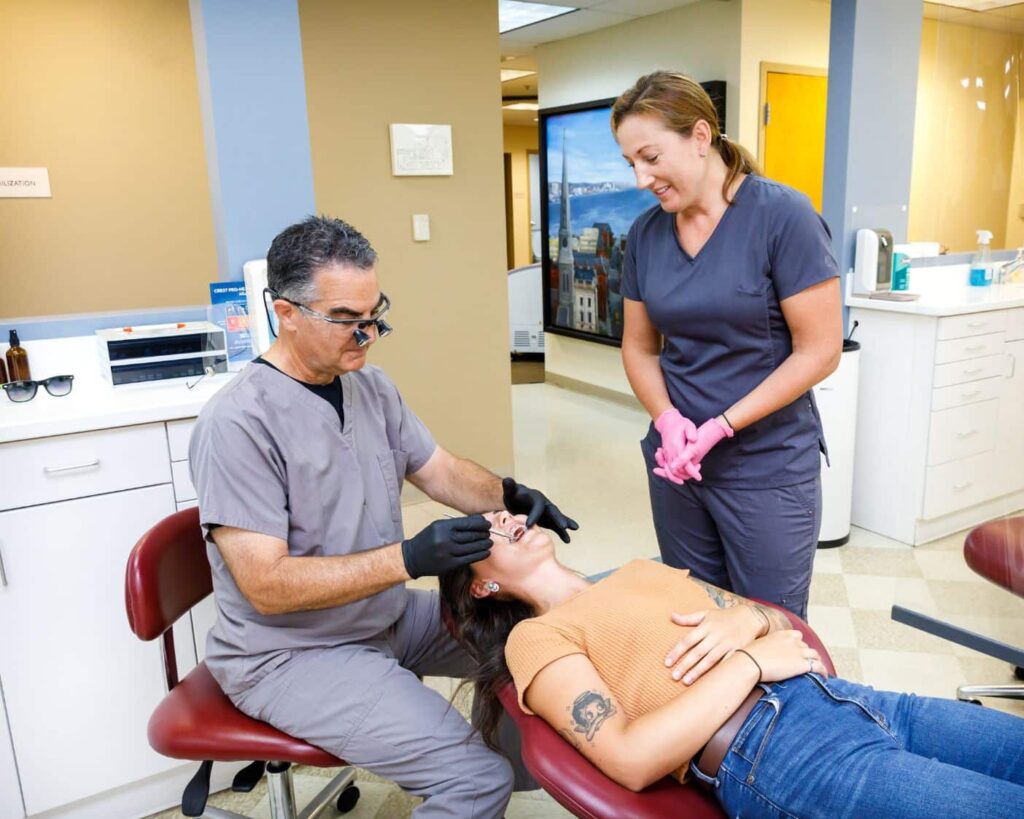 Connecticut orthodontist Dr. James O’Leary, performing braces maintenance on a patient