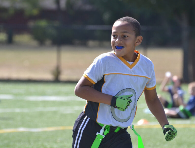 Child Outdoors Playing Sports Wearing Protective Mouth Guard